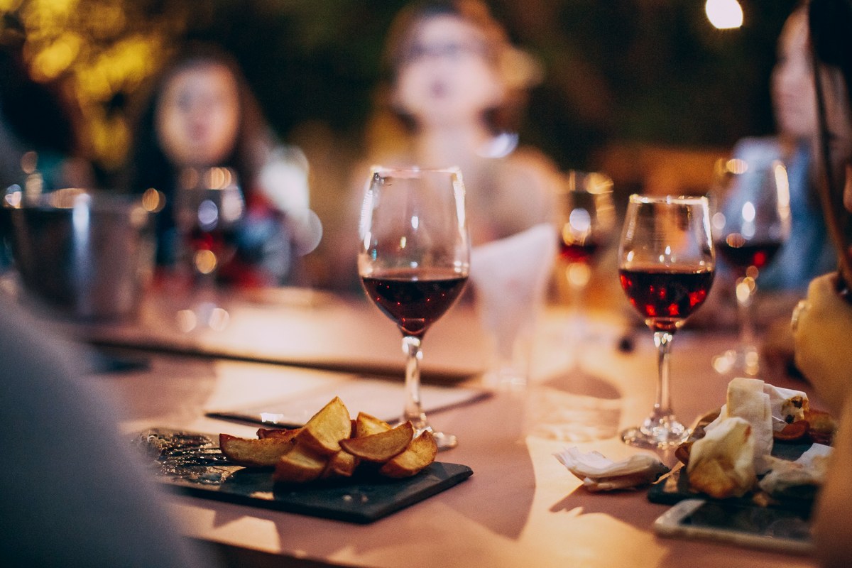 Late business dinner with red wine and fried food