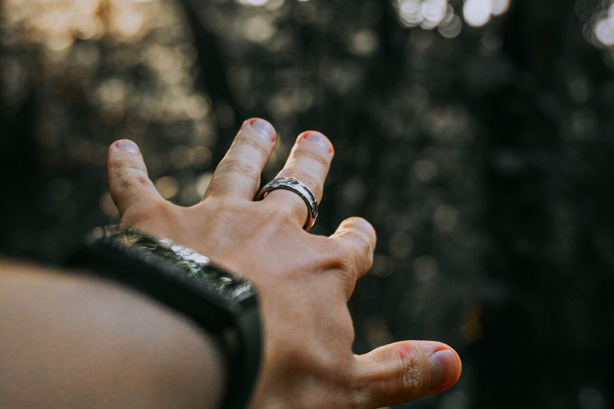 Wrist wearing a fitness tracker band and a smart ring
