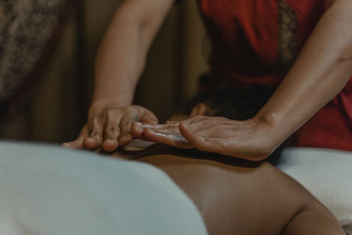 Hands giving a slow back massage in the evening